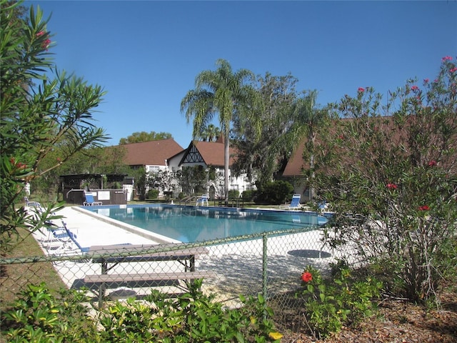 pool featuring a patio area and fence