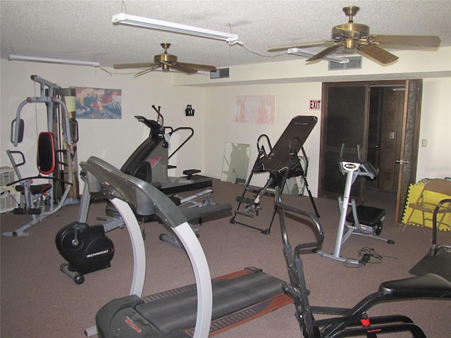 exercise room with ceiling fan, visible vents, and a textured ceiling