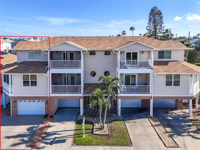 227 126th Ave, Treasure Island, FL 33706 - coastal inspired home featuring driveway, a residential view, roof with shingles, an attached garage, and stucco siding
