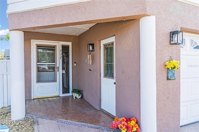 view of exterior entry featuring stucco siding