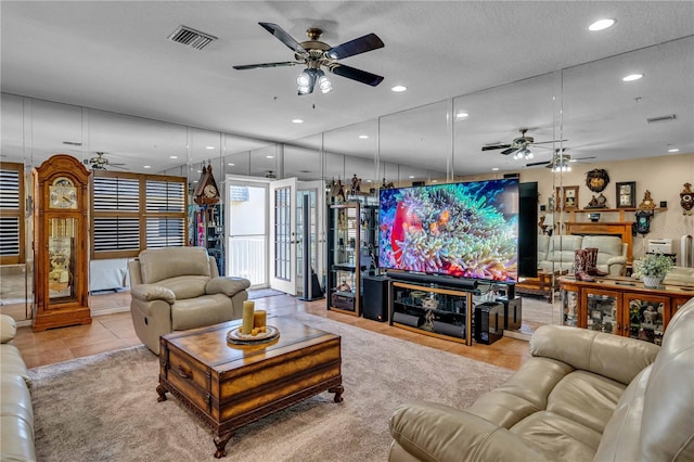 living room with light tile patterned floors, ceiling fan, visible vents, and recessed lighting