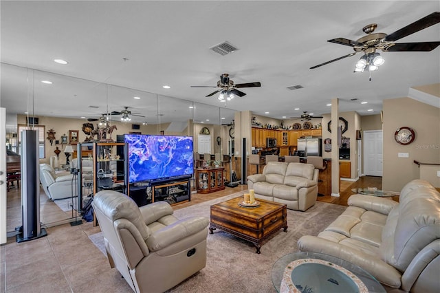 living area featuring light tile patterned floors, ceiling fan, visible vents, and recessed lighting