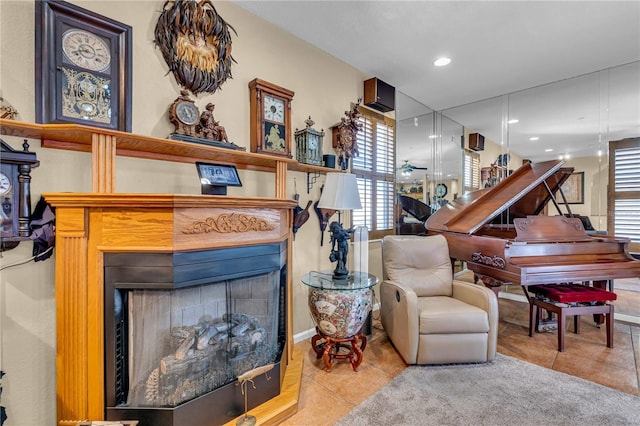 living area with recessed lighting, light tile patterned flooring, and a fireplace