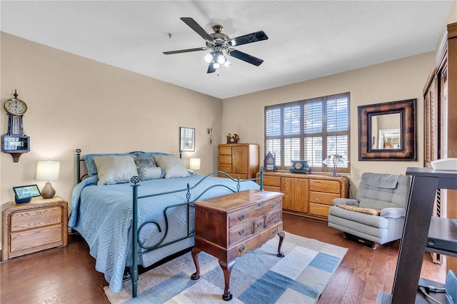 bedroom featuring dark wood-type flooring and a ceiling fan