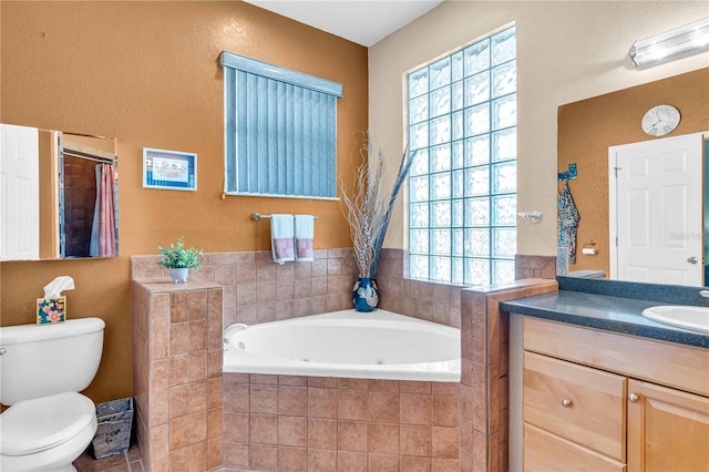 bathroom with vanity, toilet, and a bath