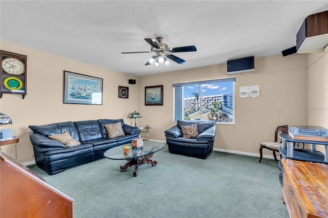 living area with carpet, ceiling fan, a textured ceiling, and baseboards