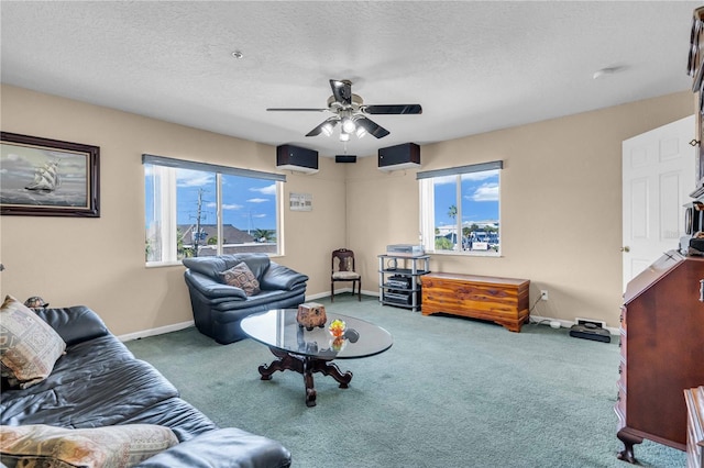 living area with a textured ceiling, baseboards, and carpet flooring