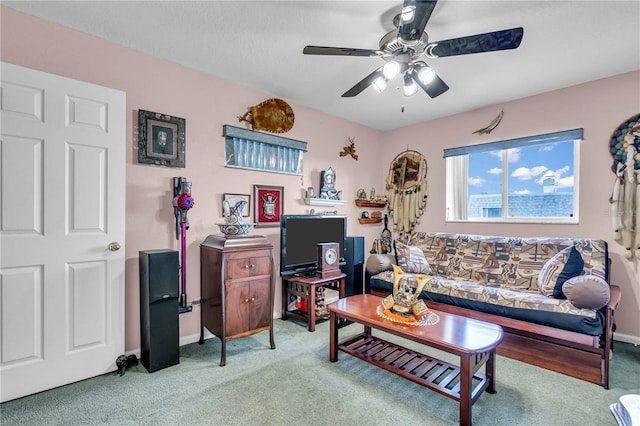 living room featuring a ceiling fan, light carpet, and baseboards