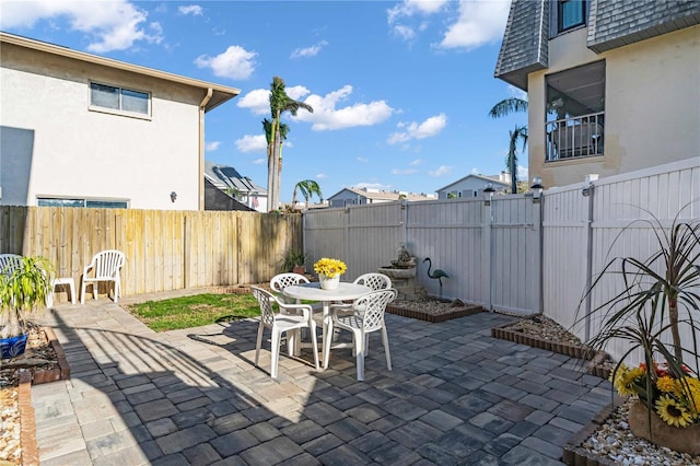 view of patio with outdoor dining space and a fenced backyard