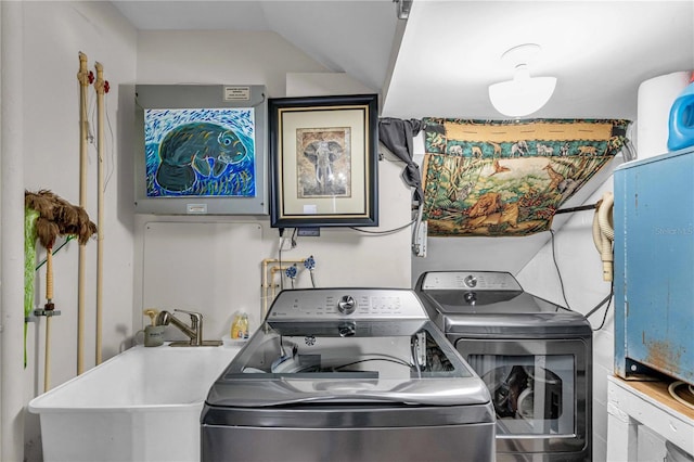 washroom with washer and dryer, laundry area, and a sink