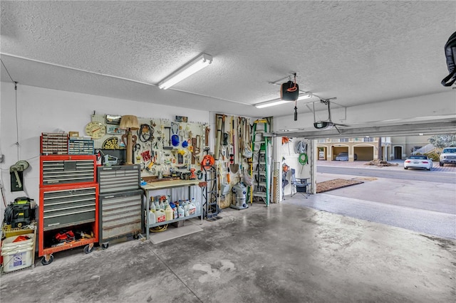 garage with a garage door opener and a workshop area