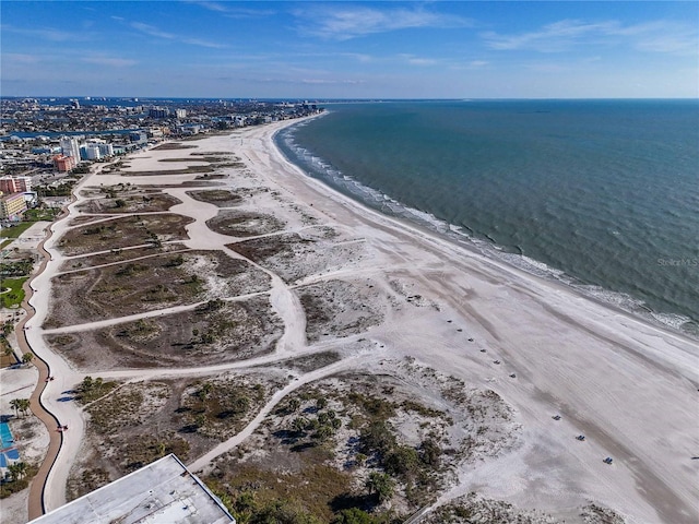 birds eye view of property featuring a water view and a beach view