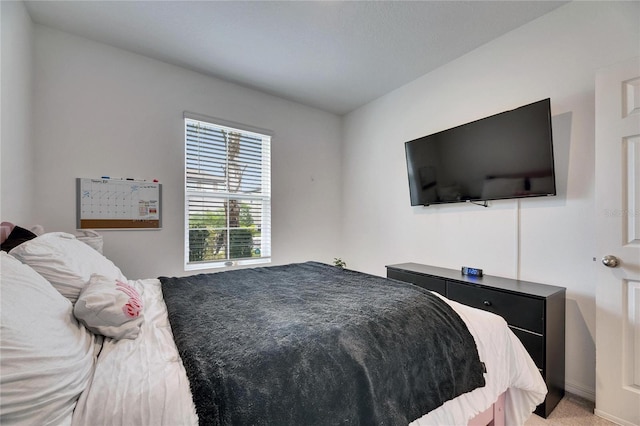 bedroom featuring light colored carpet