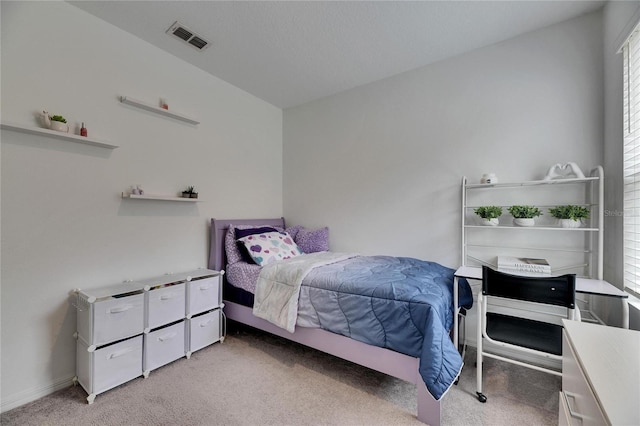 bedroom featuring visible vents and light carpet