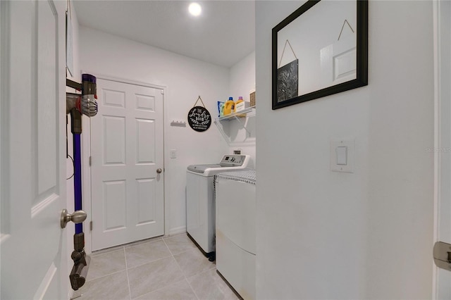 laundry area featuring laundry area, independent washer and dryer, and light tile patterned flooring