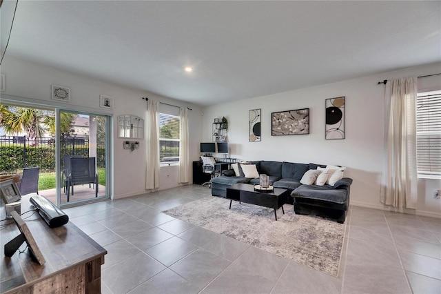 living area with baseboards and light tile patterned flooring