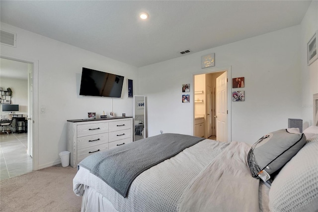 bedroom featuring baseboards, visible vents, and light colored carpet