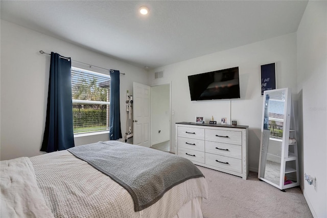 bedroom featuring light carpet, visible vents, and baseboards