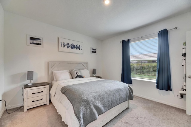 bedroom with carpet flooring and baseboards