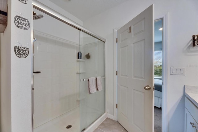 full bathroom with tile patterned flooring, a shower stall, and vanity