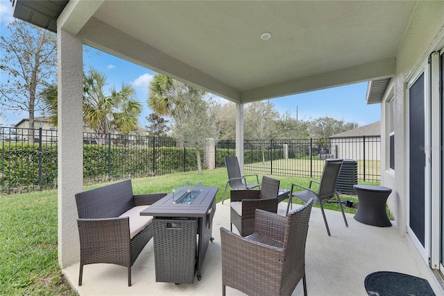 view of patio with a fenced backyard and an outdoor living space with a fire pit