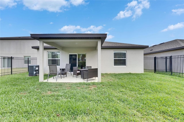 back of house featuring a fenced backyard, central AC, a yard, stucco siding, and a patio area