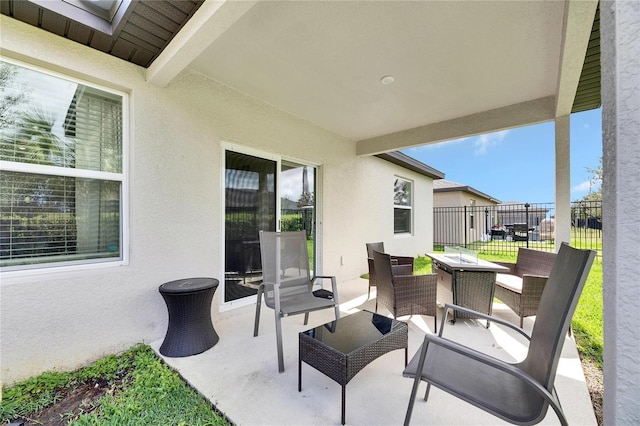 view of patio with fence and an outdoor hangout area