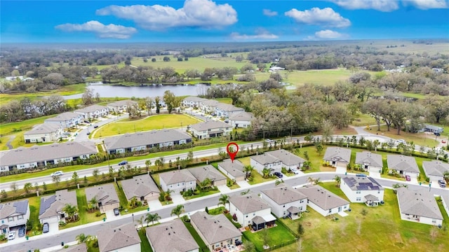 drone / aerial view with a water view and a residential view