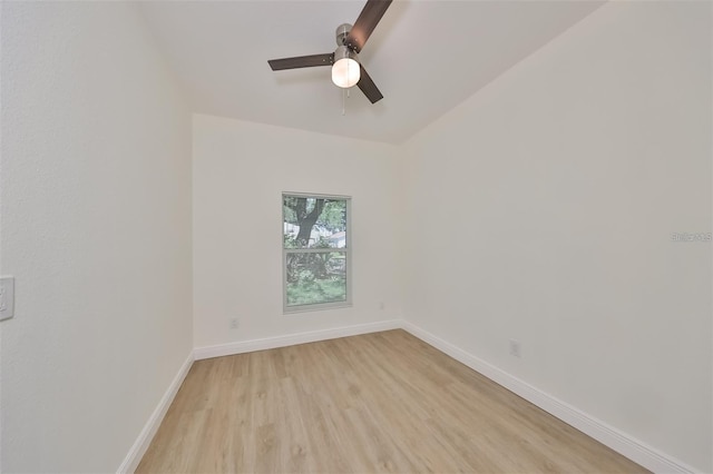 empty room featuring a ceiling fan, light wood-style flooring, and baseboards