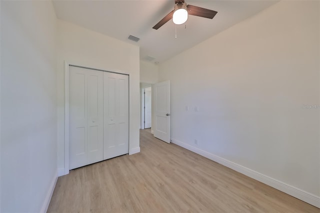 unfurnished bedroom with light wood-type flooring, a closet, visible vents, and baseboards