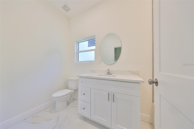 bathroom featuring marble finish floor, visible vents, toilet, and baseboards