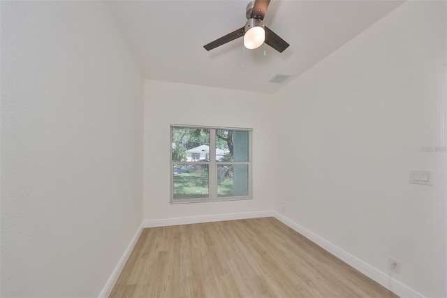 empty room with light wood finished floors, visible vents, baseboards, and ceiling fan