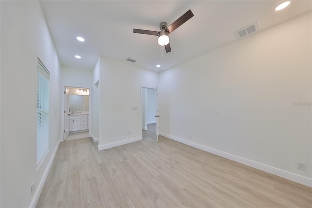 unfurnished bedroom featuring light wood-style flooring, recessed lighting, visible vents, baseboards, and ensuite bath