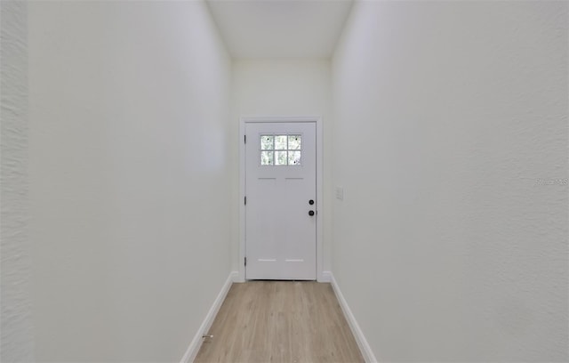 entryway featuring light wood-style flooring and baseboards