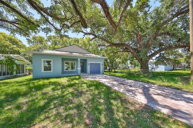 ranch-style house with an attached garage, stucco siding, concrete driveway, and a front yard