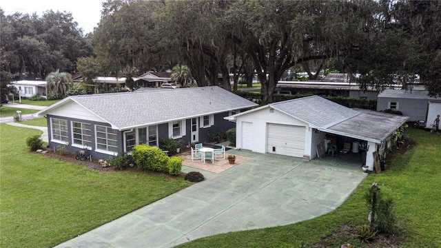 view of front facade with a front yard, a sunroom, and roof with shingles