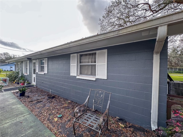 view of home's exterior with concrete block siding