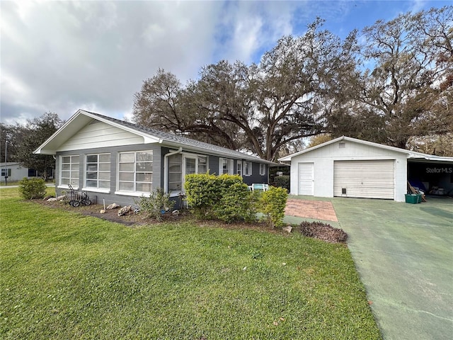 ranch-style home featuring a detached garage, a carport, and a front yard