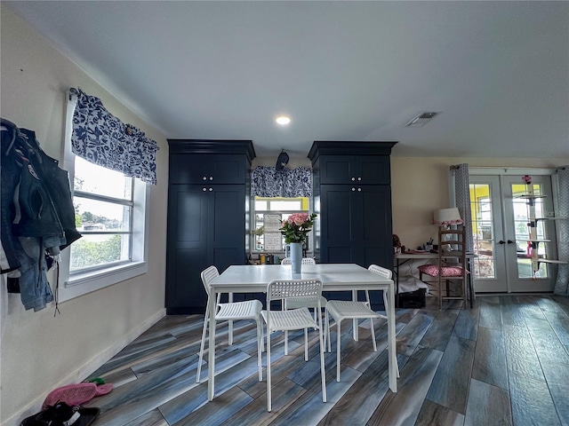 dining space with baseboards, french doors, visible vents, and wood tiled floor