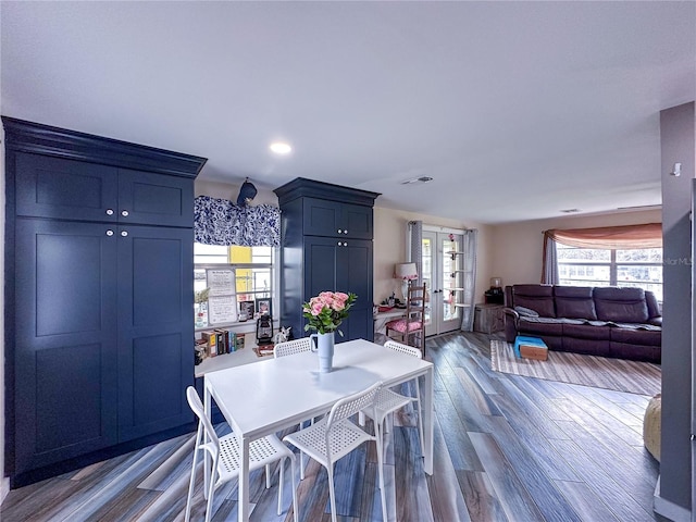 dining room with visible vents, wood finished floors, and french doors