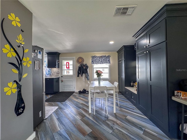 dining room with wood finish floors and visible vents