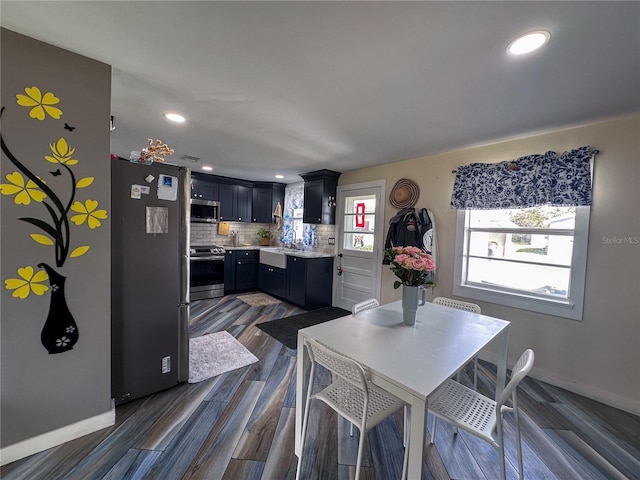 dining room featuring recessed lighting, dark wood finished floors, and baseboards