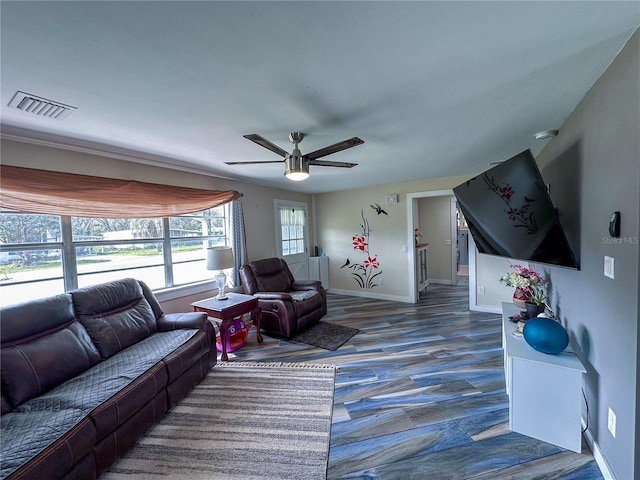 living room featuring ceiling fan, dark wood-style floors, visible vents, and baseboards