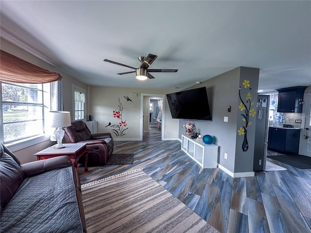 living room featuring a ceiling fan, dark wood finished floors, and baseboards