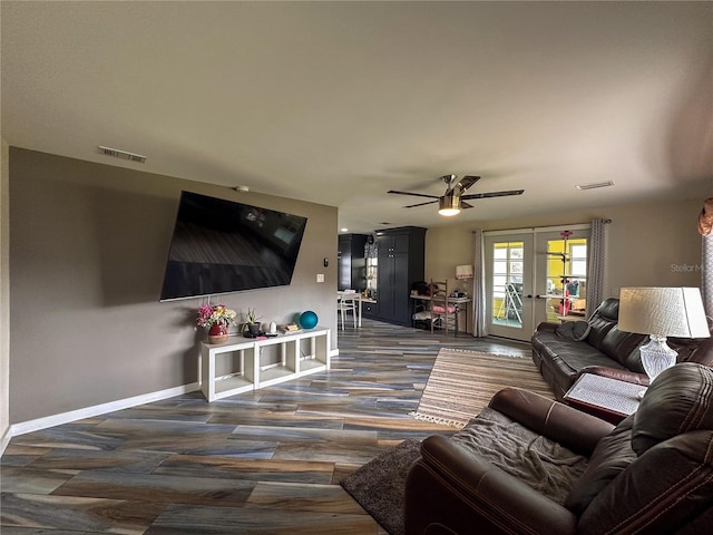 living area with french doors, visible vents, ceiling fan, and baseboards