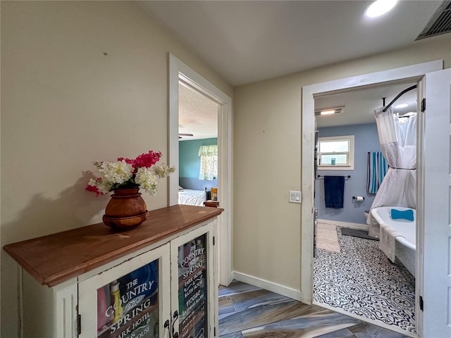 interior space featuring wood finished floors, visible vents, and baseboards