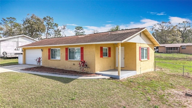 view of front facade with stucco siding, concrete driveway, fence, a garage, and a front lawn