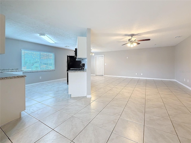 kitchen featuring light tile patterned floors, a textured ceiling, visible vents, white cabinetry, and a ceiling fan