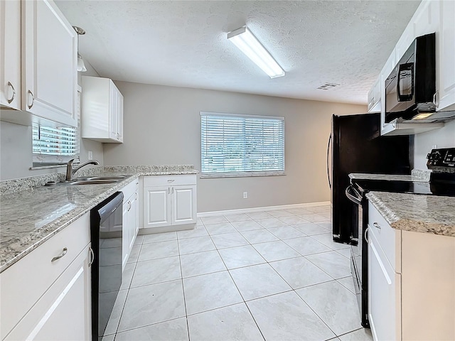 kitchen featuring visible vents, white cabinetry, a sink, light tile patterned flooring, and black appliances