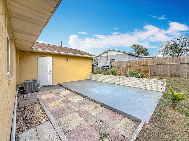 view of patio / terrace featuring fence and central AC